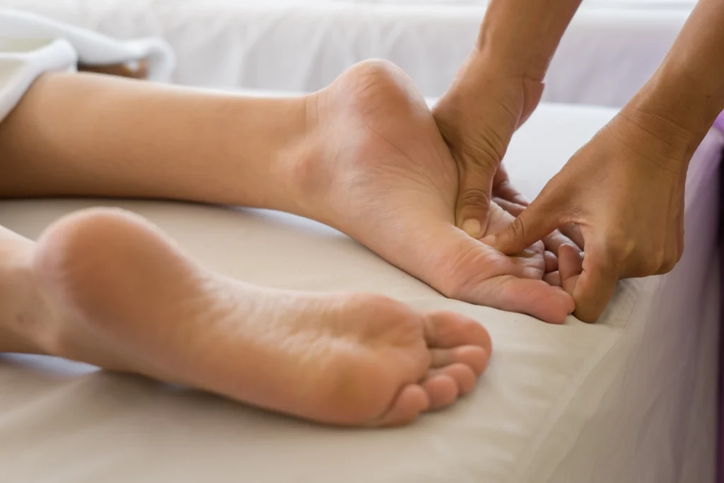 close up woman doing foot massage spa